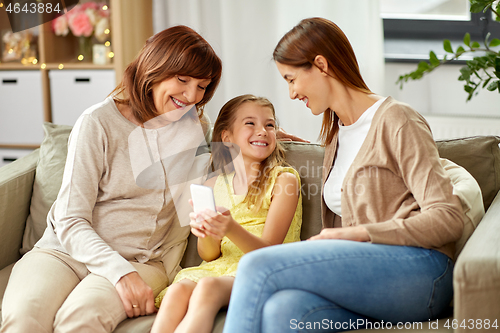 Image of mother, daughter and grandmother with smartphone