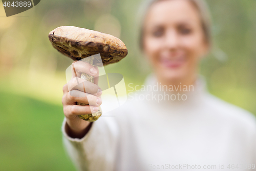 Image of close up of woman with mushroom in forest