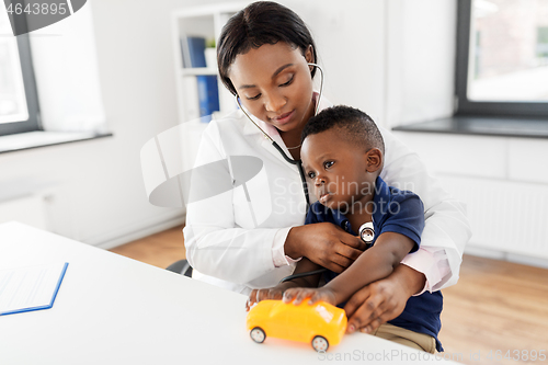 Image of doctor with stethoscope and baby patient at clinic