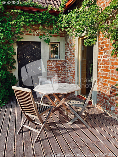 Image of terrace with wooden table and chairs