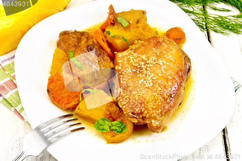 Image of Chicken roast with pumpkin and dried apricots on white board
