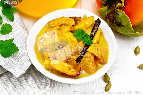 Image of Persimmons baked with honey in dish on table