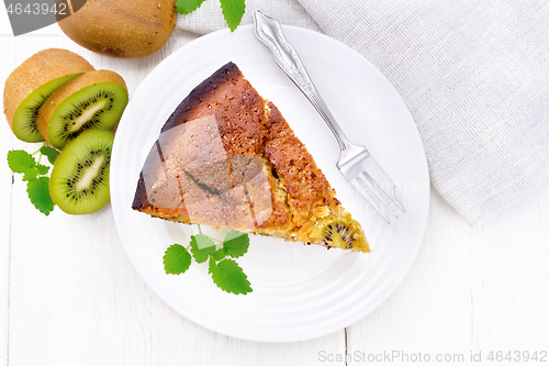 Image of Pie with kiwi in plate on board top