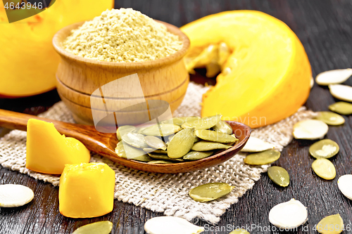 Image of Pumpkin seeds in spoon on board