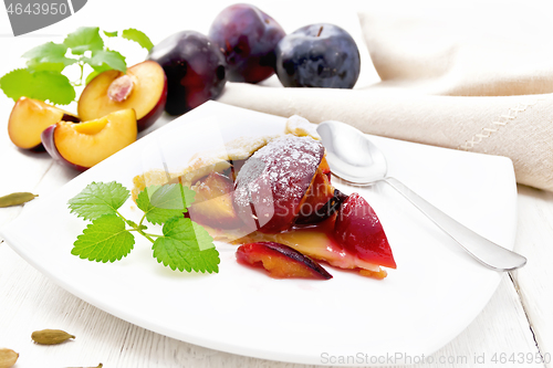 Image of Galeta with plums in plate on white board