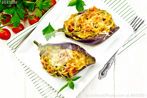 Image of Eggplant stuffed smoked brisket in plate on wooden board top