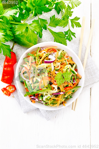 Image of Salad of cucumber in bowl on white board top