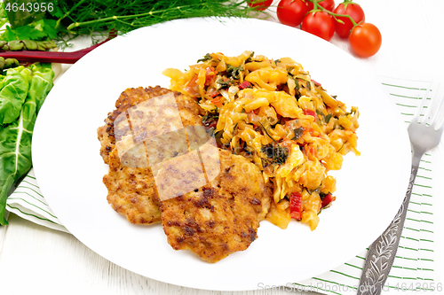 Image of Fritters meat with cabbage in plate on white board