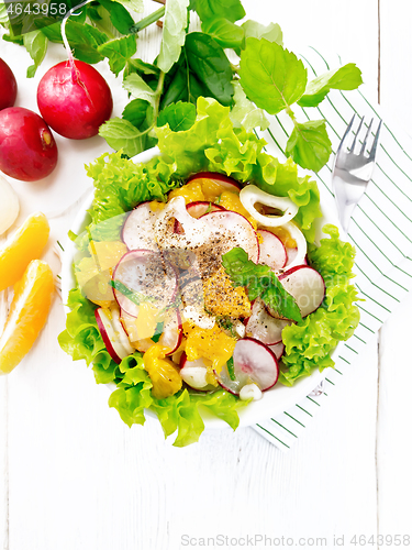 Image of Salad of radish and orange with mint on white board top