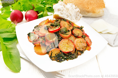 Image of Radish with spinach and spices in plate on light board