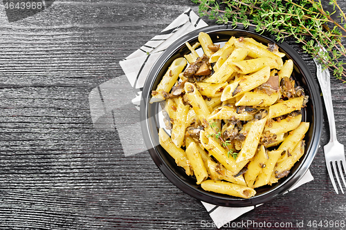 Image of Pasta with mushrooms in plate on black board top