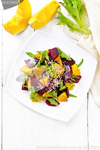 Image of Salad of pumpkin and beetroot in plate on light board top