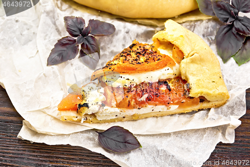 Image of Galeta with tomato and cheese on table