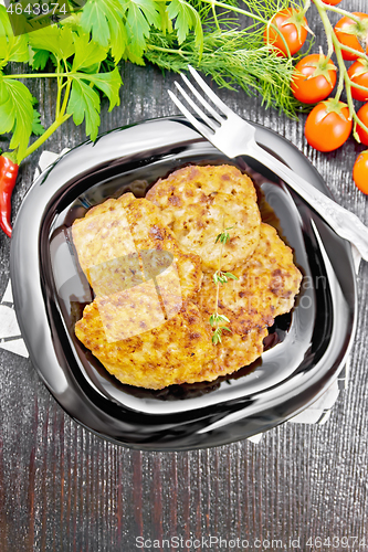 Image of Fritters meat in plate on black board top