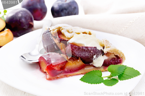 Image of Galeta with plums in plate on light table