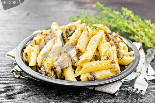 Image of Pasta with mushrooms in plate on black board