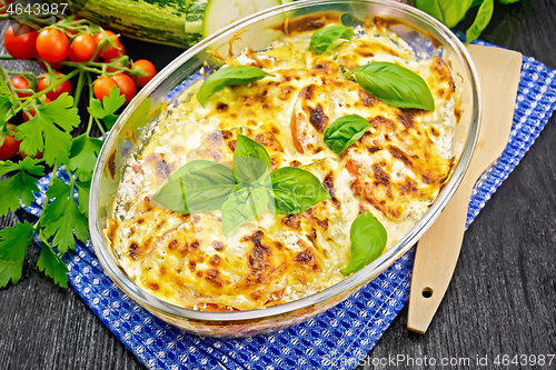 Image of Zucchini baked with tomatoes in pan on towel