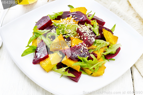 Image of Salad of pumpkin and beetroot in plate on board