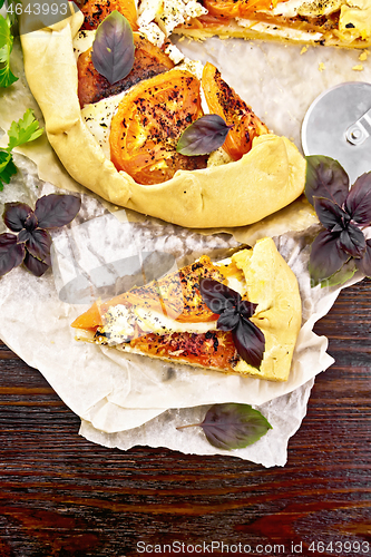 Image of Galeta with tomato and cheese on parchment top