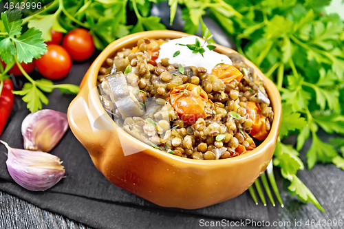 Image of Lentils with eggplant and tomatoes in bowl on table
