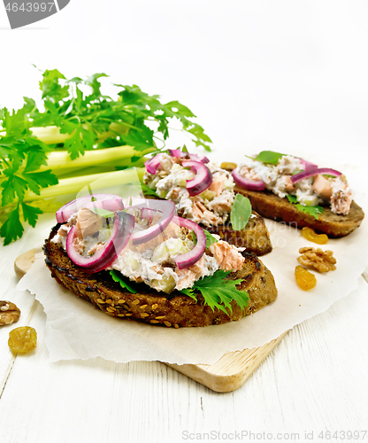 Image of Bruschetta with fish and curd on light board