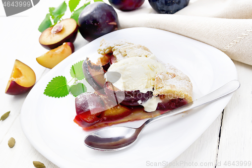 Image of Galeta with plums in plate on white table