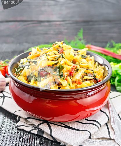 Image of Cabbage stew with chard in bowl on wooden board