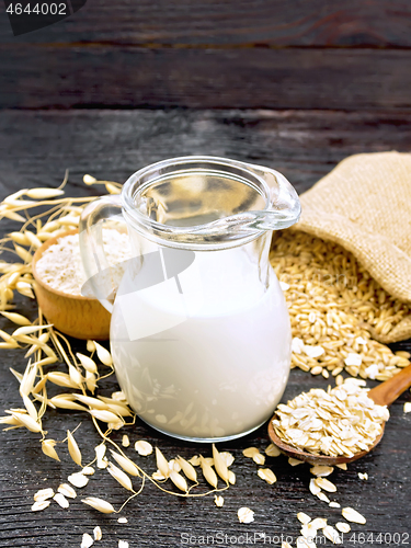 Image of Milk oatmeal in jug on wooden board