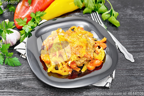 Image of Chicken with pepper in plate on wooden board