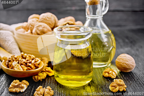 Image of Oil walnut in jar and decanter on dark board