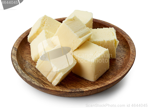 Image of butter pieces on wooden plate