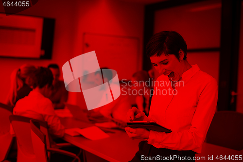 Image of business woman on meeting  using tablet