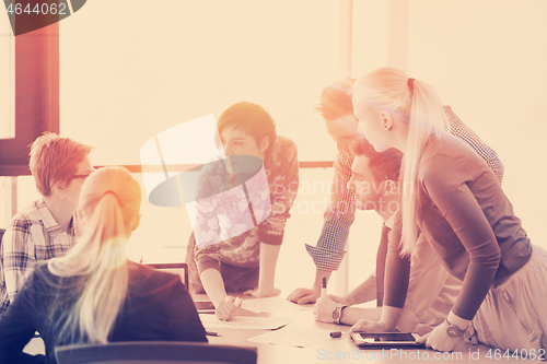 Image of startup business team on meeting at modern office with sunset in