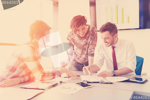 Image of startup business team on meeting at modern office with sunset in