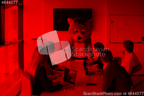 Image of boss dresed as bear having fun with business people in trendy of