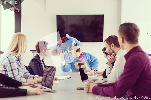 Image of boss dresed as bear having fun with business people in trendy of