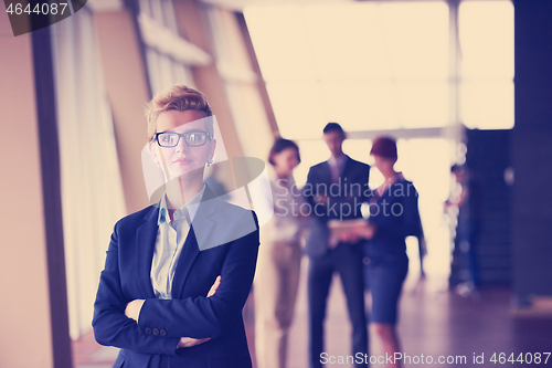 Image of business people group, woman in front  as team leader