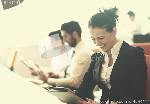 Image of business woman on meeting  using tablet