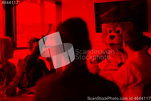 Image of boss dresed as bear having fun with business people in trendy of