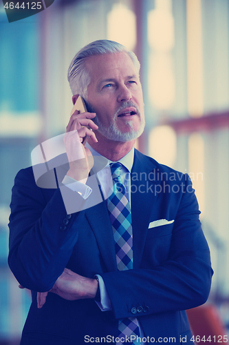 Image of senior business man talk on mobile phone