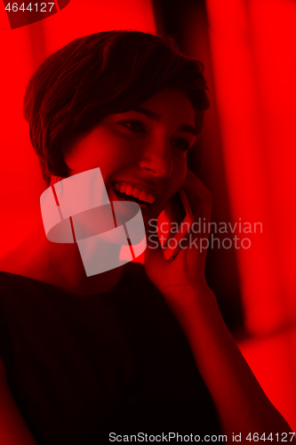 Image of Elegant Woman Using Mobile Phone in office building