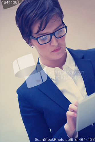 Image of business woman working on tablet