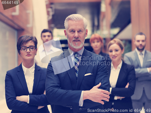 Image of senior business man with his team at office