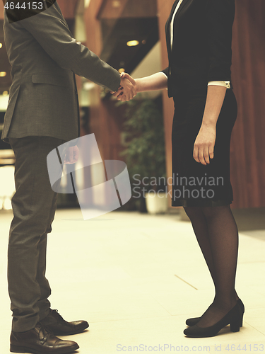 Image of businesswoman and businessman handshake