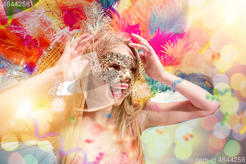 Image of Beautiful young woman in carnival mask