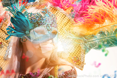 Image of Beautiful young woman in carnival mask