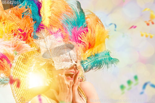 Image of Beautiful young woman in carnival mask