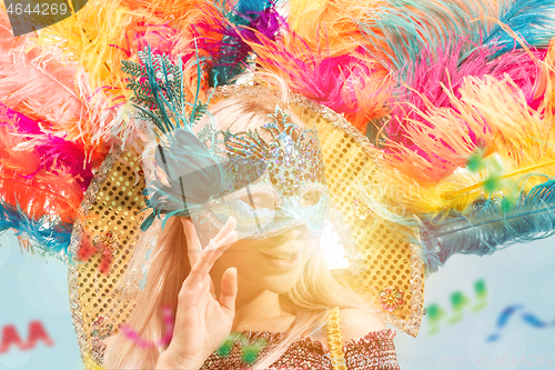 Image of Beautiful young woman in carnival mask