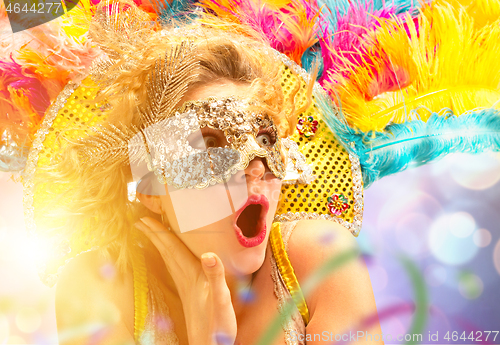 Image of Beautiful young woman in carnival mask