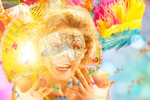 Image of Beautiful young woman in carnival mask